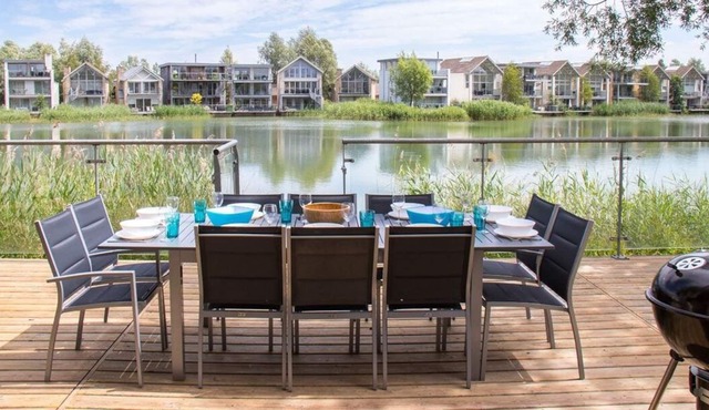 A contemporary glass fronted lake side home that sleeps 10 guests in 5 bedrooms in Somerford Keynes